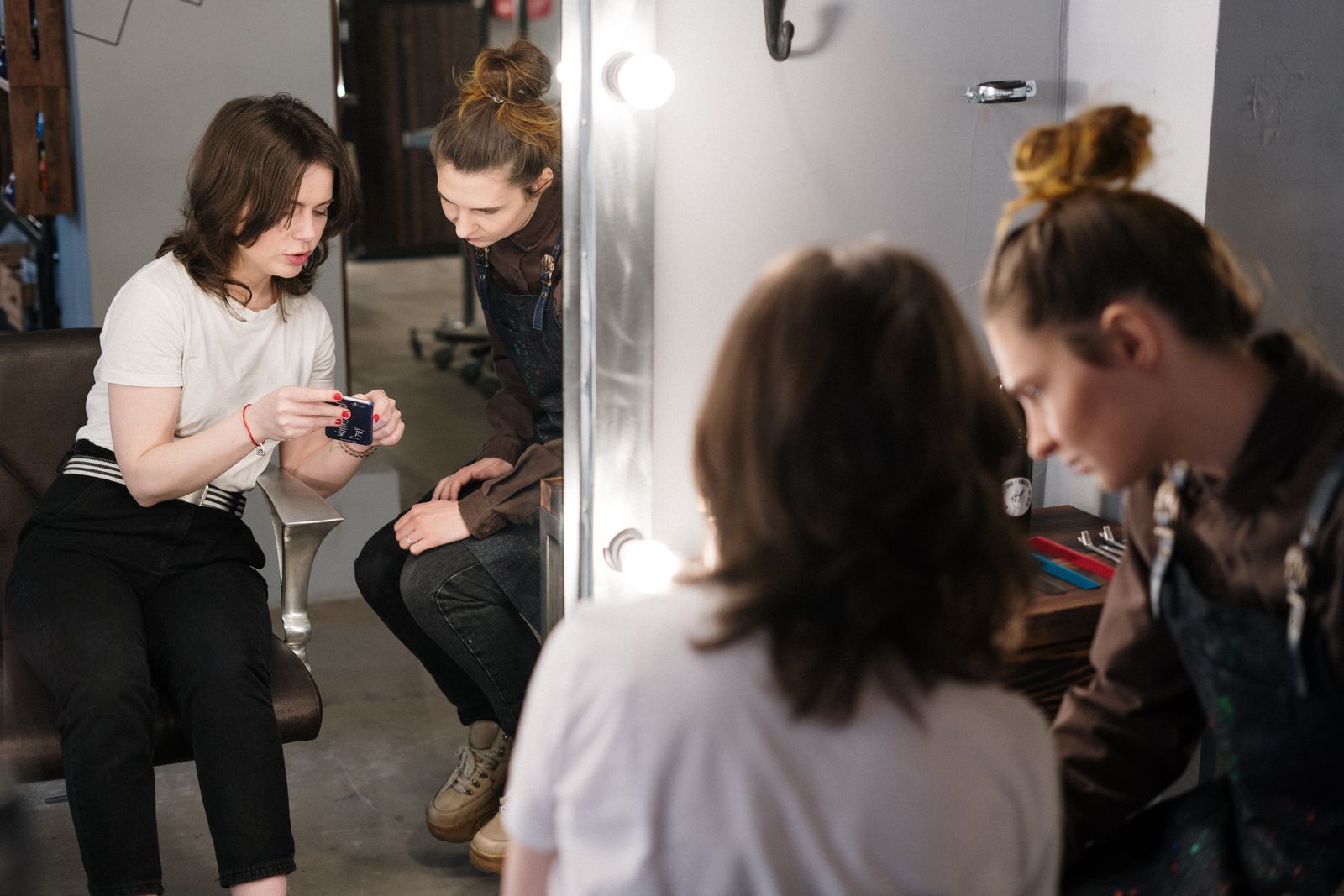 Stylist consulting a client at a beauty salon — building trust that earns 5-star reviews